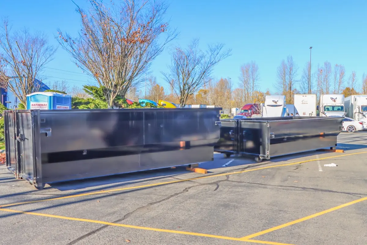 Professional dumpster rental service with roll-off container on residential driveway in Manteca